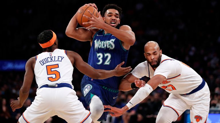 Minnesota Timberwolves center Karl-Anthony Towns drives to the basket against New York Knicks guard Immanuel Quickley and New York Knicks center Taj Gibson. 