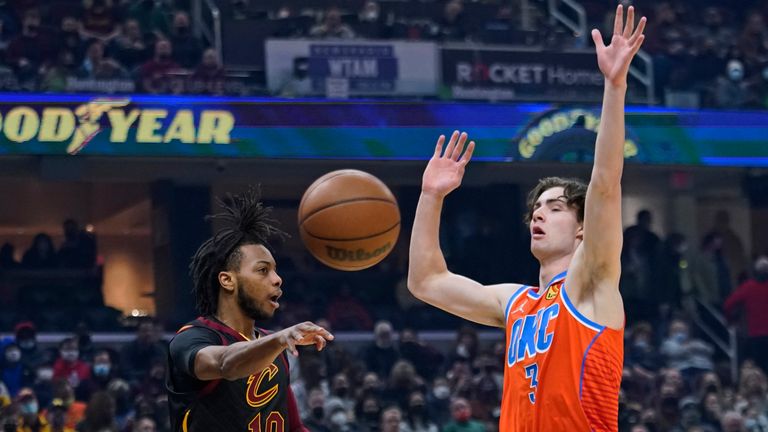 Cleveland Cavaliers&#39; Darius Garland (10) passes the ball away from Oklahoma City Thunder&#39;s Josh Giddey (3) during the first half of an NBA basketball game, Saturday, Jan. 22, 2022, in Cleveland. The Cavaliers won 94-87. (AP Photo/Tony Dejak)