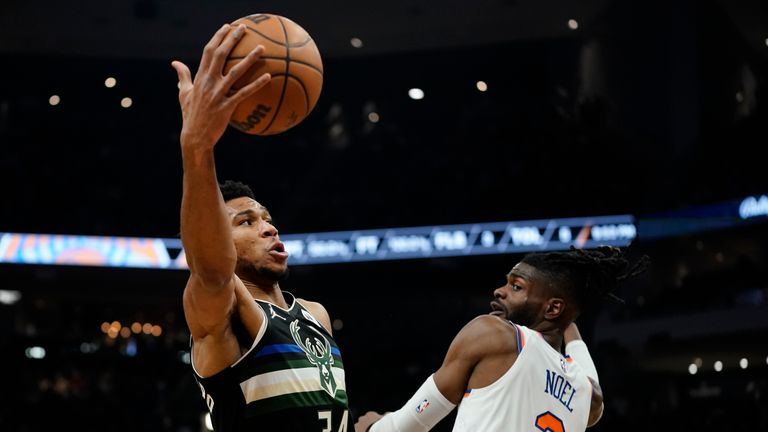 Milwaukee Bucks' Giannis Antetokounmpo shoots past New York Knicks' Nerlens Noel during the first half of an NBA basketball game Friday, Jan. 28, 2022, in Milwaukee. (AP Photo/Morry Gash)