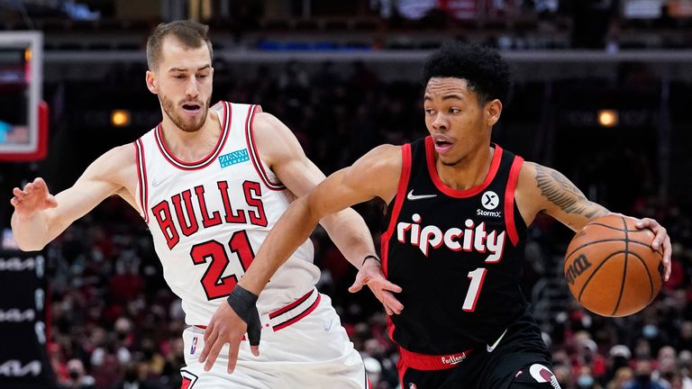 Portland Trail Blazers guard Anfernee Simons drives as Chicago Bulls guard Matt Thomas guards during the first half of an NBA basketball game in Chicago, Sunday, Jan. 30, 2022.