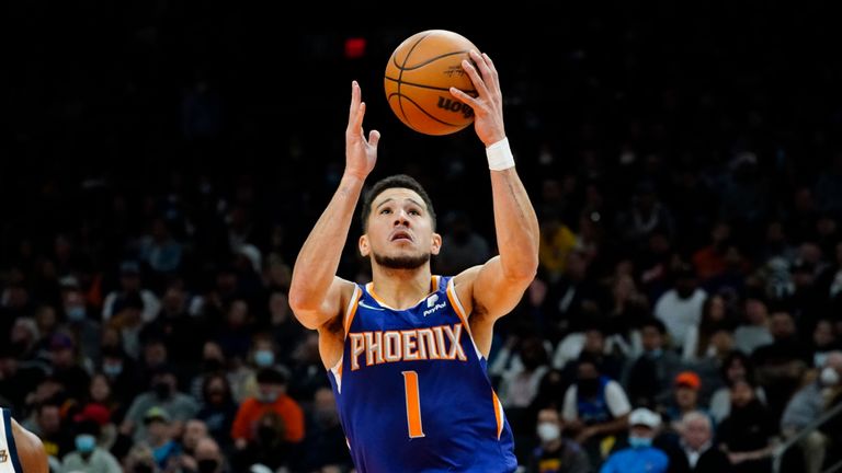 Phoenix Suns guard Devin Booker (1) drives against the Utah Jazz during the first half of an NBA basketball game, Monday, Jan. 24, 2022, in Phoenix. (AP Photo/Matt York)


