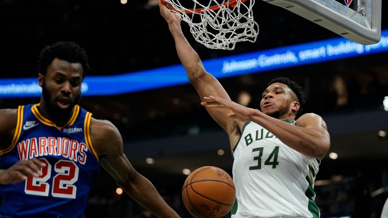 Milwaukee Bucks&#39; Giannis Antetokounmpo dunks past Golden State Warriors&#39; Andrew Wiggins during the second half of an NBA basketball game Thursday, Jan. 13, 2022, in Milwaukee. (AP Photo/Morry Gash)


