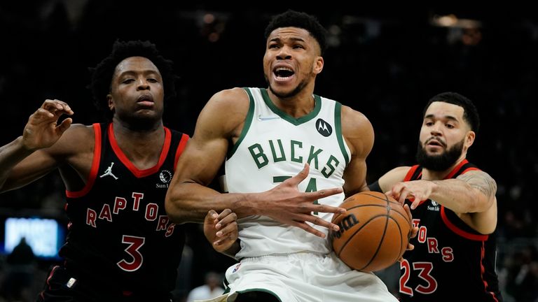 Milwaukee Bucks&#39; Giannis Antetokounmpo is fouled driving between Toronto Raptors&#39; OG Anunoby and Fred VanVleet during the second half of an NBA basketball game Saturday, Jan. 15, 2022, in Milwaukee. The Raptors won 103-96.