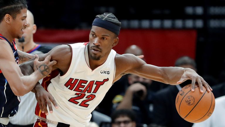 Miami Heat forward Jimmy Butler (22) is defended by Houston Rockets guard Jalen Green during the second half of an NBA basketball game Friday, Dec. 31, 2021, in Houston. 