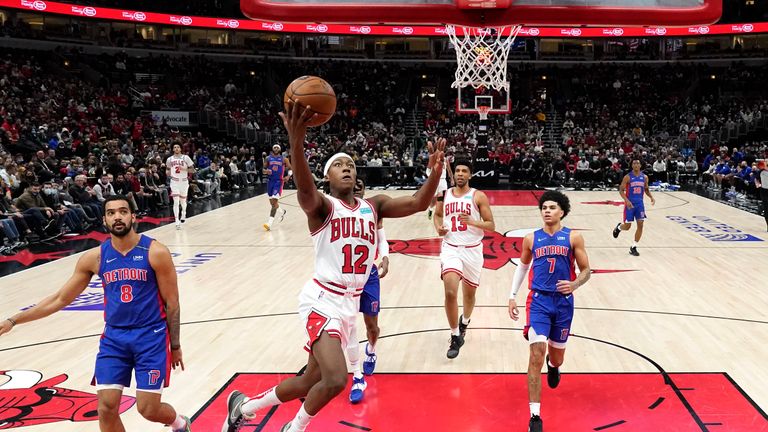 Chicago Bulls&#39; Ayo Dosunmu scores past Detroit Pistons&#39; Trey Lyles (8) and Killian Hayes (7) during the first half of an NBA basketball game Tuesday, Jan. 11, 2022, in Chicago. (AP Photo/Charles Rex Arbogast)