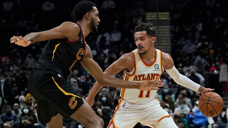 Atlanta Hawks 'Trae Young (11) leads against Cleveland Cavaliers' Evan Mobley (4) in the second half of an NBA basketball game, Friday, December 31, 2021, in Cleveland.
