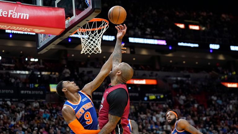Miami Heat forward P.J. Tucker, right, shoots as New York Knicks guard RJ Barrett (9) defends