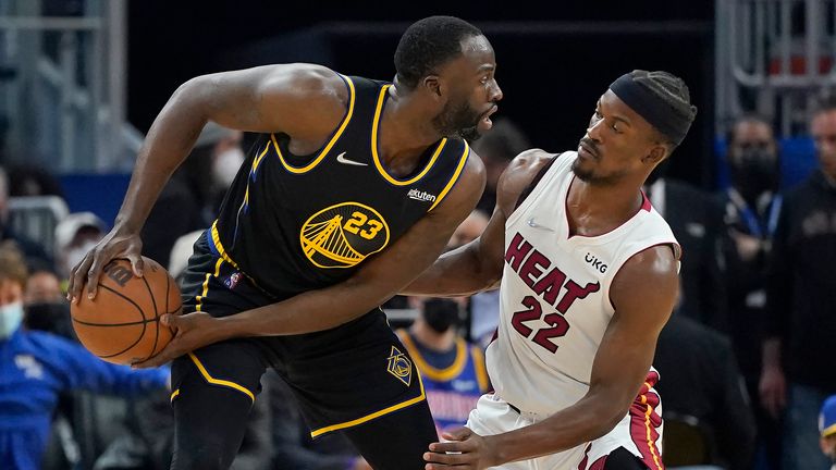 Golden State Warriors forward Draymond Green, left, is defended by Miami Heat forward Jimmy Butler (22) during the first half of an NBA basketball game in San Francisco, Monday, Jan. 3, 2022.