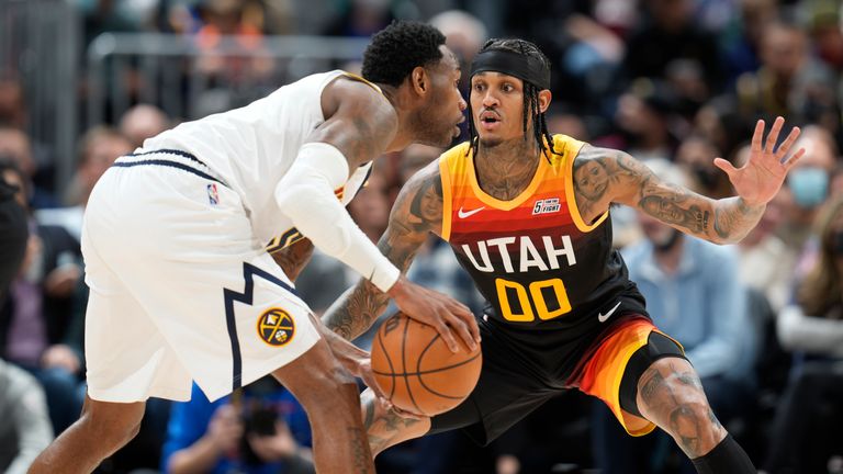 Denver Nuggets forward Will Barton, front, looks to pass the ball as Utah Jazz guard Jordan Clarkson defends in the second half of an NBA basketball game