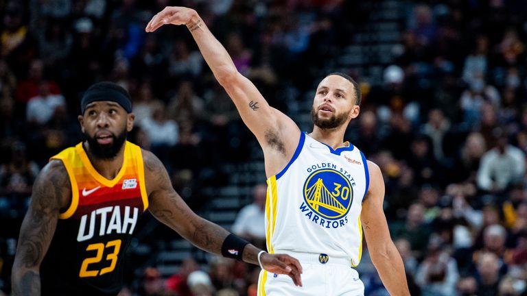 Golden State Warriors guard Stephen Curry (30) holds his follow-through on his shot while guarded by Utah Jazz forward Royce O&#39;Neale (23) in the first half during an NBA basketball game Saturday, Jan. 1, 2022, in Salt Lake City. 