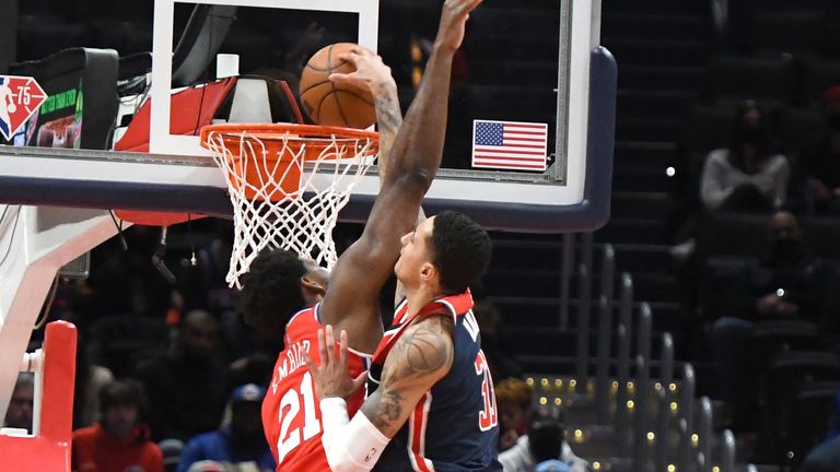 Kyle Kuzma #33 of the Washington Wizards dunks the ball over Joel Embiid #21 of the Philadelphia 76ers in the second quarter during at the Capital One Arena on January 17, 2022 in Washington, DC.