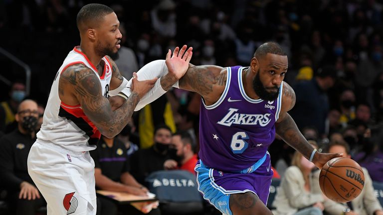 Los Angeles Lakers forward LeBron James (6) drives around Portland Trail Blazers guard Damian Lillard during the first half of an NBA basketball game on Friday, December 31, 2021, in Los Angeles.