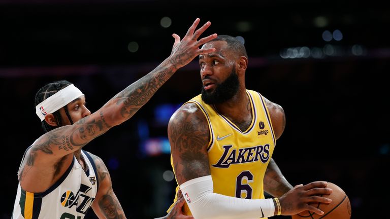 Los Angeles Lakers forward LeBron James (6) is defended by Utah Jazz guard Jordan Clarkson (00) during the second half of an NBA basketball game in Los Angeles, Monday, Jan. 17, 2022. The Lakers won 101-95.