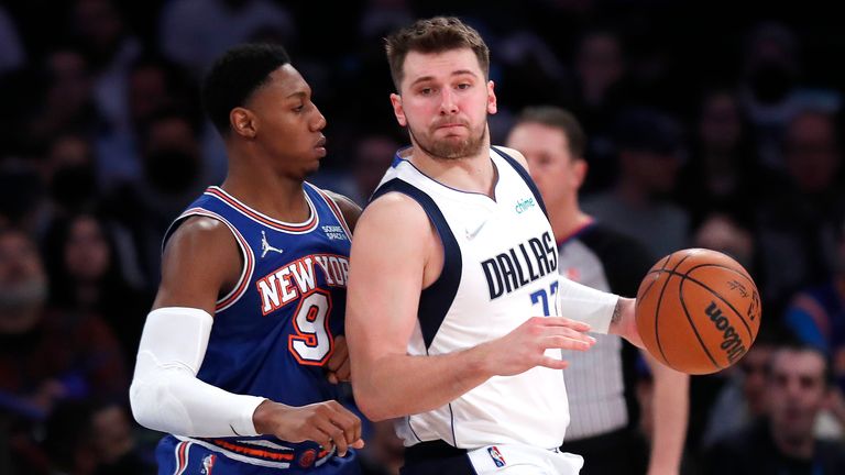 New York Knicks guard RJ Barrett (9) defends against Dallas Mavericks guard Luka Doncic (77) during the second half of an NBA basketball game, Wednesday, Jan. 12, 2022 in New York. 