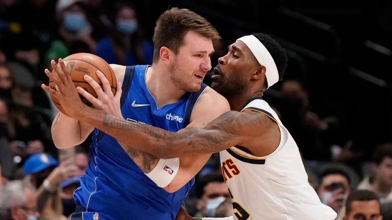 Dallas Mavericks guard Luka Doncic, left, is defended by Denver Nuggets forward Will Barton (5) during the second half of an NBA basketball game in Dallas, Monday, Jan. 3, 2022. 