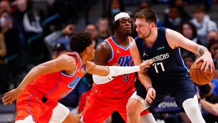 Dallas Mavericks guard Luka Doncic (77) battles Oklahoma City Thunder forward Luguentz Dort (5) and guard Aaron Wiggins (21) for space during the second half of an NBA basketball game, Monday, Jan. 17, 2022, in Dallas.