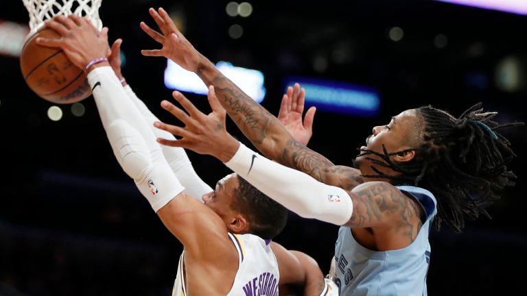 Los Angeles Lakers guard Russell Westbrook, left, grabs a rebound in front of Memphis Grizzlies guard Ja Morant, right, during the first half of an NBA basketball game Sunday, Jan. 9, 2022, in Los Angeles. (AP Photo/Alex Gallardo)


