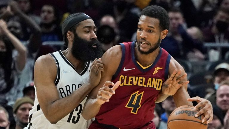 Cleveland Cavaliers&#39; Evan Mobley (4) tries to get past Brooklyn Nets&#39; James Harden (13) in the second half of an NBA basketball game, Monday, Jan. 17, 2022, in Cleveland. 