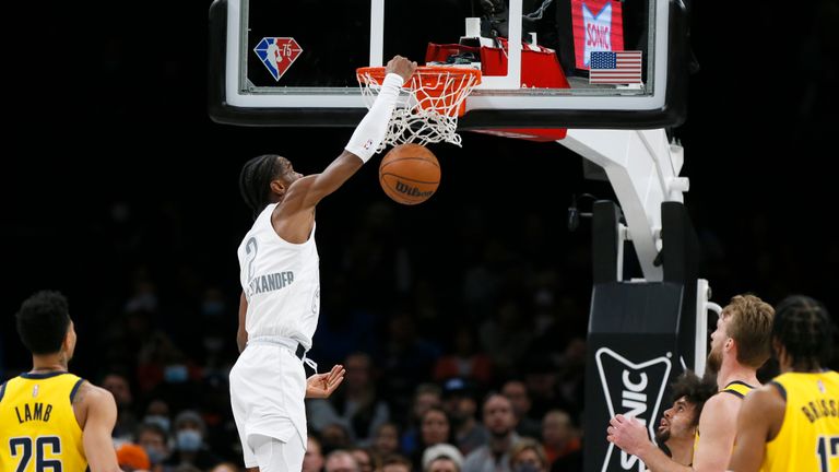 Oklahoma City Thunder guard Shai Gilgeous-Alexander, middle, dunks the ball as, from left, Indiana Pacers guard Jeremy Lamb, guard Duane Washington Jr., center Domantas Sabonis and forward Oshae Brissett watch in the first half of an NBA basketball game Friday, Jan. 28, 2022, in Oklahoma City. (AP Photo/Nate Billings)