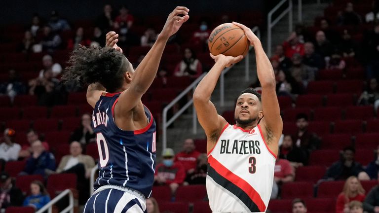 Portland Trail Blazers guard CJ McCollum (3) shoots as Houston Rockets guard Jalen Green defends during the first half of an NBA basketball game, Friday, Jan. 28, 2022, in Houston. (AP Photo/Eric Christian Smith)