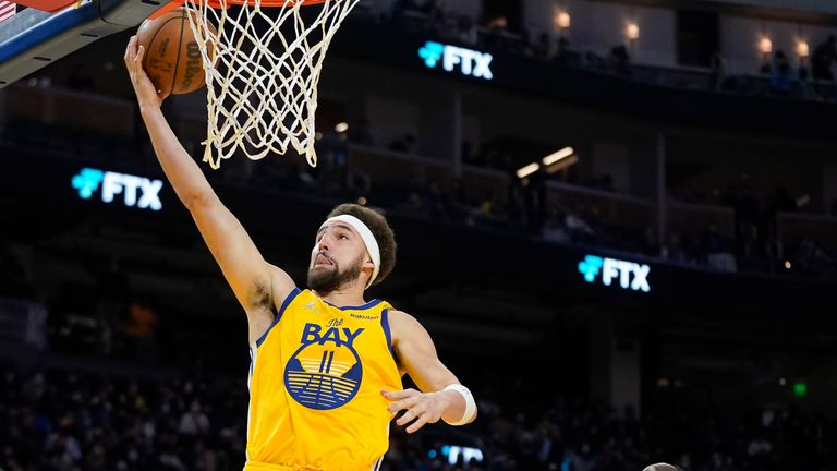 Golden State Warriors guard Klay Thompson scores over Minnesota Timberwolves forward Taurean Prince during the second half of an NBA basketball game in San Francisco, Thursday, Jan. 27, 2022.