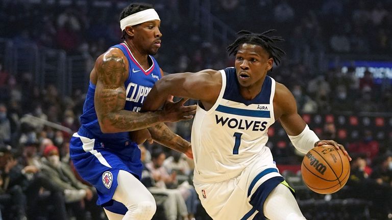 Minnesota Timberwolves forward Anthony Edwards, right, drives toward the basket as Los Angeles Clippers guard Eric Bledsoe defends during the first half of an NBA basketball game Monday, Jan. 3, 2022, in Los Angeles.