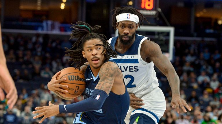 Memphis Grizzlies defender Ja Morant handles the ball in front of Minnesota Timberwolves defender Patrick Beverley in the first half of an NBA basketball game on Thursday, January 13, 2022 in Memphis, Tenn.  (AP Photo / Brandon Dill)