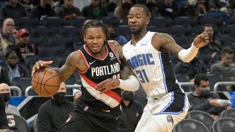 Portland Trail Blazers guard Ben McLemore, left, drives to the basket in front of Orlando Magic guard Terrence Ross (31) during the first half of an NBA basketball game, Monday, Jan. 17, 2022, in Orlando, Fla.