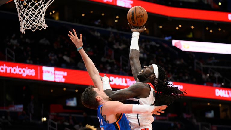 Washington Wizards center Montrezl Harrell, right, goes to the basket over Oklahoma City Thunder center Mike Muscala (33) during the first half of an NBA basketball game, Tuesday, Jan. 11, 2022, in Washington. Muscala was charged with a foul on the play. (AP Photo/Nick Wass)