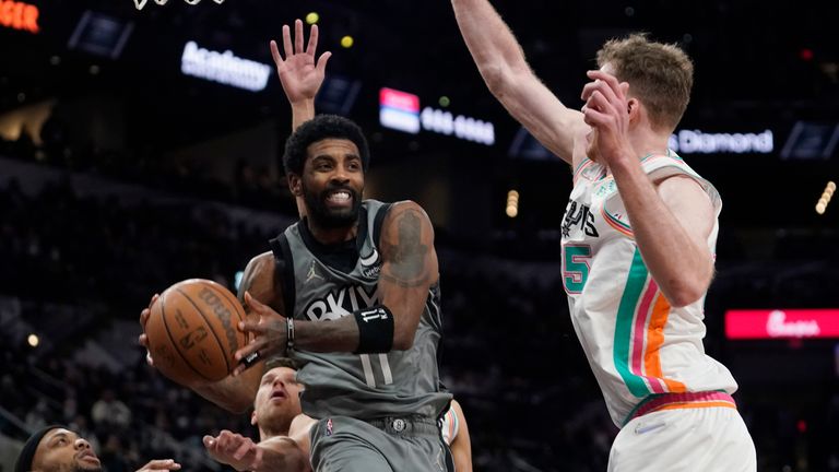 Brooklyn Nets guard Kyrie Irving drives to the basket against San Antonio Spurs center Jakob Poeltl