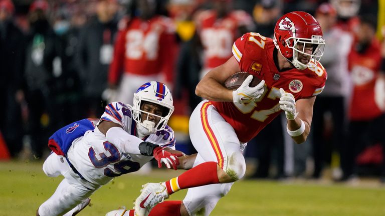 Kansas City Chiefs tight end Travis Kelce (87) runs from Buffalo Bills cornerback Levi Wallace (39) after catching a pass during the second half of an NFL divisional round playoff football game, Sunday, Jan. 23, 2022, in Kansas City, Mo.