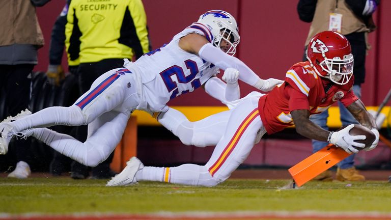 Kansas City Chiefs wide receiver Mecole Hardman scores on a 25-yard touchdown run ahead of Buffalo Bills safety Micah Hyde (23) during the second half of an NFL divisional round playoff football game, Sunday, Jan. 23, 2022, in Kansas City, Mo. 