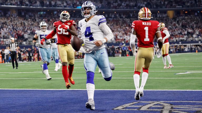 Dallas Cowboys quarterback Dak Prescott (4) scores runs the ball for a touchdown as San Francisco 49ers&#39; Charles Omenihu (92) and Jimmie Ward (1) defend in the second half of an NFL wild-card playoff football game in Arlington, Texas, Sunday, Jan. 16, 2022.