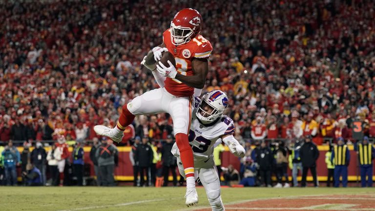 Kansas City Chiefs wide receiver Byron Pringle (13) catches a 2-yard touchdown pass ahead of Buffalo Bills safety Micah Hyde (23) during the first half of an NFL divisional round playoff football game, Sunday, Jan. 23, 2022, in Kansas City, Mo.