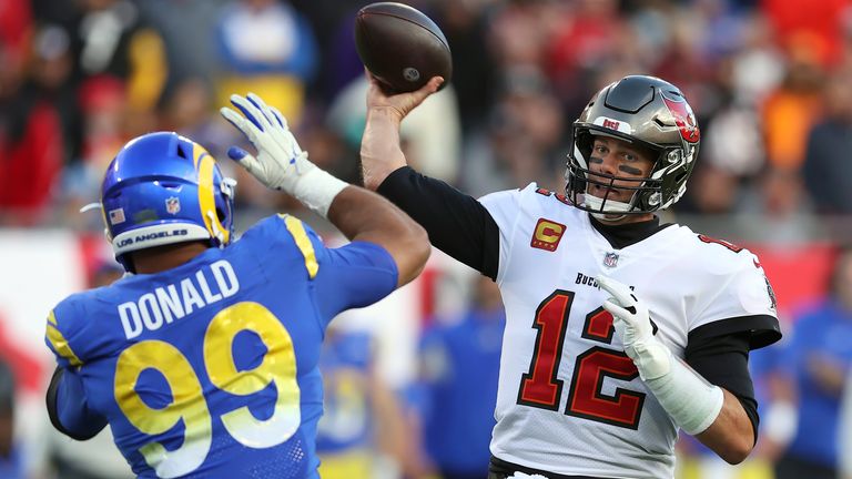 Los Angeles Rams defensive end Aaron Donald (99) tries to block a pass by Tampa Bay Buccaneers quarterback Tom Brady (12) during the second half of an NFL divisional round playoff football game Sunday, Jan. 23, 2022, in Tampa, Fla.