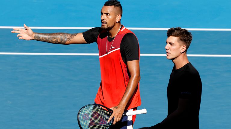 Nick Kyrgios, left, and partner Thanasi Kokkinakis of Australia react during their doubles match against Germany's Tim Puetz and Michael Venus of New Zealand at the Australian Open tennis championships in Melbourne, Australia, Tuesday, Jan. 25, 2022. (AP Photo/Tertius Pickard)