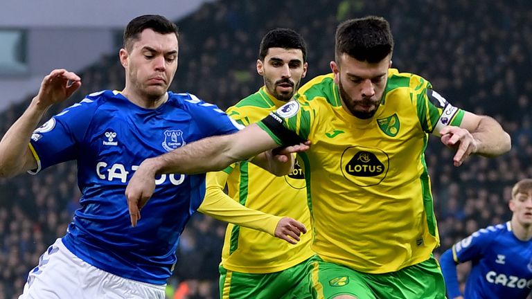 Michael Keane and Grant Hanley challenge for the ball 