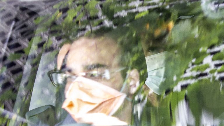 A person believed to be Novak Djokovic (R) is pictured in the back seat of a car leaving the immigration detention centre where he has been staying in Melbourne