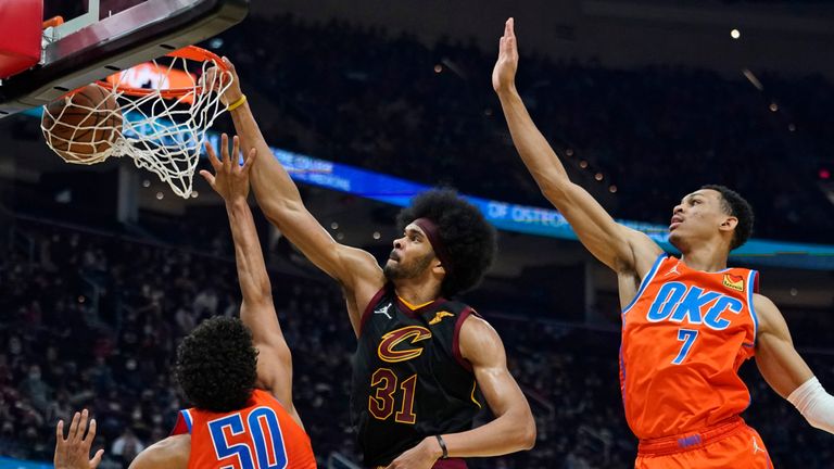 Cleveland Cavaliers&#39; Jarrett Allen (31) dunks the ball against Oklahoma City Thunder&#39;s Jeremiah Robinson-Earl (50) Darius Bazley (7) and in the first half of an NBA basketball game, Saturday, Jan. 22, 2022, in Cleveland. (AP Photo/Tony Dejak)