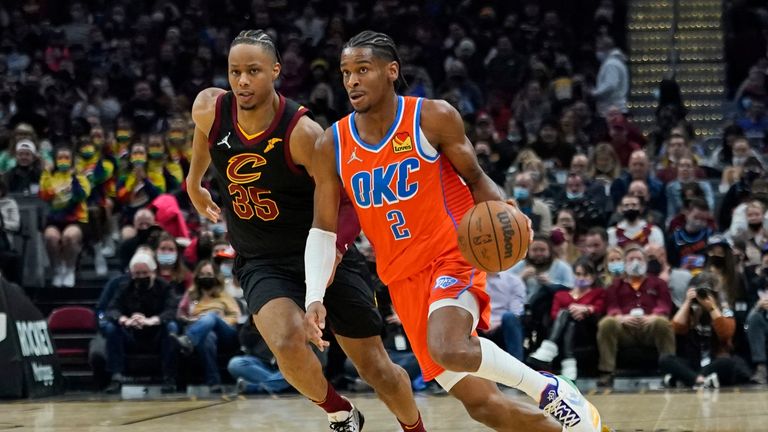 Oklahoma City Thunder&#39;s Shai Gilgeous-Alexander (2) drives against Cleveland Cavaliers&#39; Isaac Okoro (35) in the second half of an NBA basketball game, Saturday, Jan. 22, 2022, in Cleveland. (AP Photo/Tony Dejak)