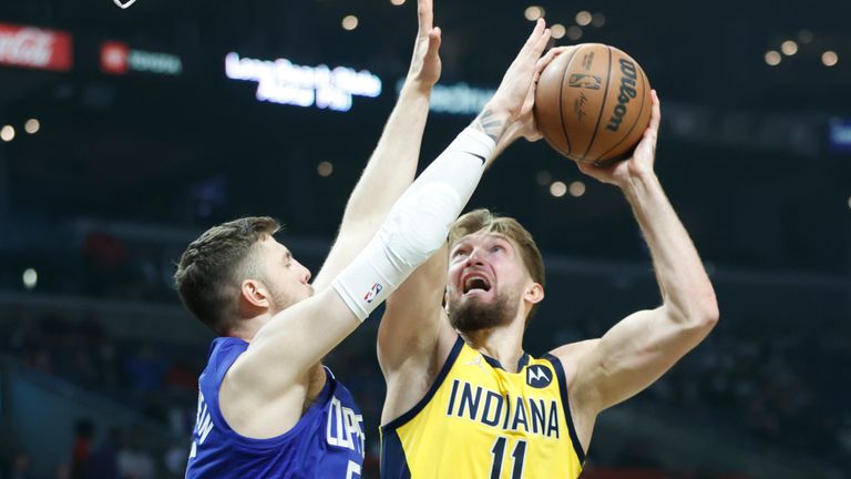 Indiana Pacers forward Domantas Sabonis (11) shoots against Los Angeles Clippers Center Isaiah Hartenstein (55) during the first half of an NBA basketball game in Los Angeles, Monday, Jan. 17, 2022. 