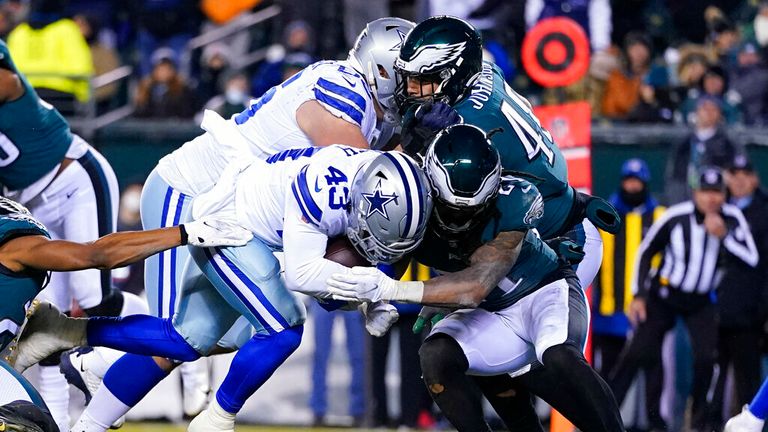 Philadelphia Eagles defensive back Andre Chachere (21) tries to stop Dallas Cowboys running back Ito Smith (43) from scoring a touchdown during the second half of an NFL football game, Saturday, Jan. 8, 2022, in Philadelphia. (AP Photo/Julio Cortez)