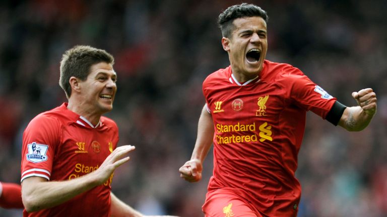 Liverpool's Philippe Coutinho celebrates with teammate Steven Gerrard after scoring against Manchester City