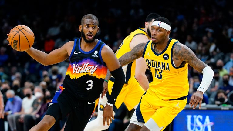 Phoenix Suns guard Chris Paul (3) drives past Indiana Pacers forward Torrey Craig (13) during the second half of an NBA basketball game Saturday, Jan. 22, 2022, in Phoenix. The Suns won 113-103. (AP Photo/Ross D. Franklin)