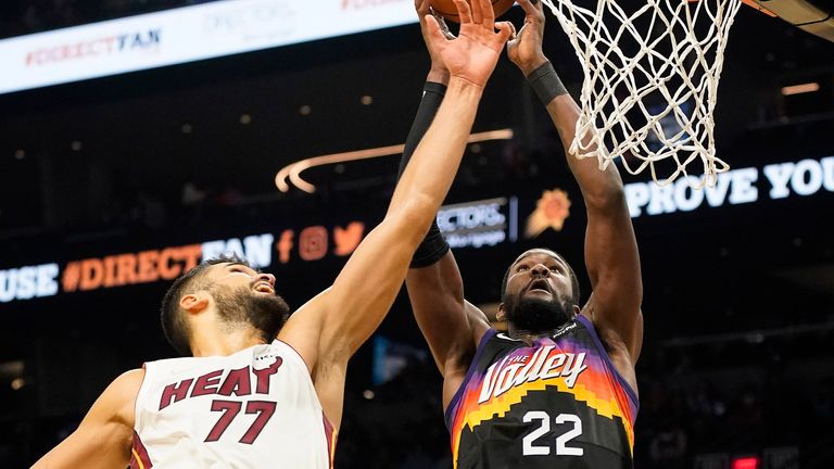 Phoenix Suns&#39; Deandre Ayton is fouled going the basket by Miami Heat&#39;s Omer Yurtseven.