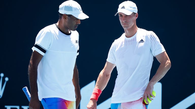 Rajeev Ram (L) of United States and Joe Salisbury of Great Britain talk tactics in their second round doubles match against Marcus Daniell of New Zealand and Frederik Nielsen of Denmark during day six of the 2022 Australian Open at Melbourne Park on January 22, 2022 in Melbourne, Australia. (Photo by Daniel Pockett/Getty Images)