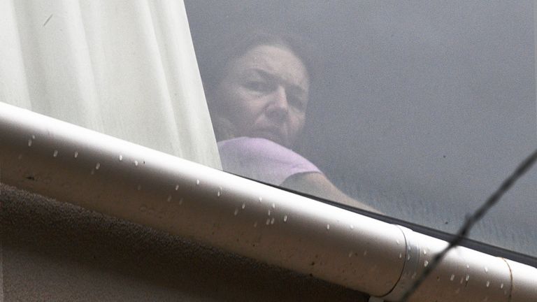 A person believed to be Renata Voracova looks out of a window at the Park hotel immigration detention centre in Melbourne, Australia