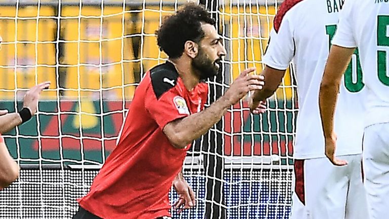 Egypt's forward Mohamed Salah (C) celebrates after scoring his team's first goal during the Africa Cup of Nations (CAN) 2021 quarter-final football match between Egypt and Morocco at Stade Ahmadou Ahidjo in Yaounde on January 30, 2022. (Photo by CHARLY TRIBALLEAU / AFP) (Photo by CHARLY TRIBALLEAU/AFP via Getty Images)