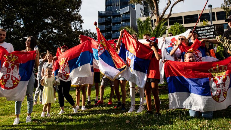 A growing Serbian presence has gathered outside the Melbourne quarantine hotel where Djokovic is staying