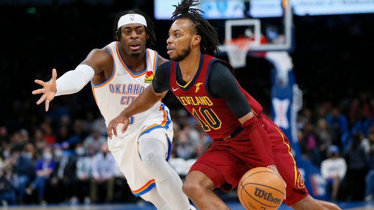 Cleveland Cavaliers guard Darius Garland drives against Oklahoma City Thunder guard Luguentz Dort in the first half of an NBA basketball game Saturday, Jan. 15, 2022, in Oklahoma City